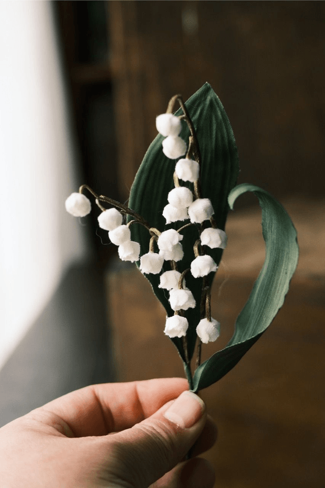 Lily of the valley in cat vase